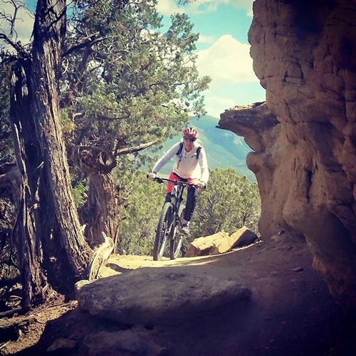 Person riding a mountain bike along a rocky trail