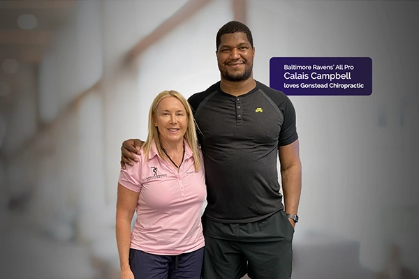 Chiropractor Laurie Trapp With Football Player
